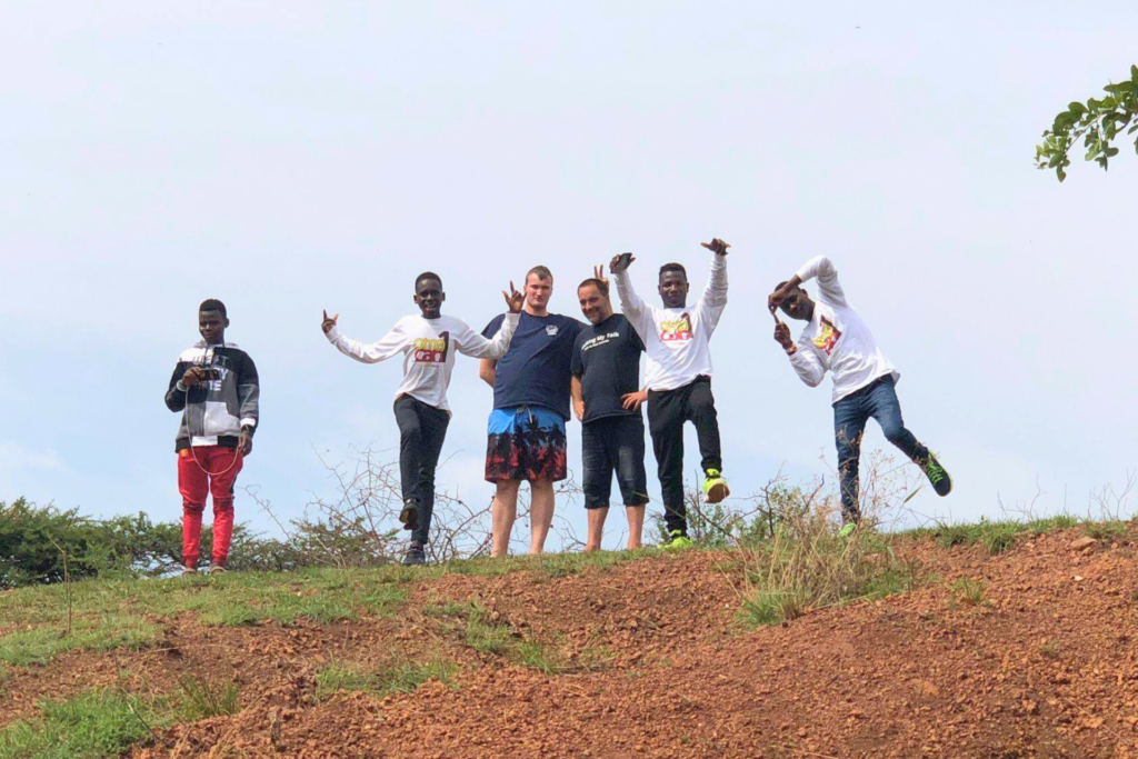 Omacan youth and volunteers on hillside