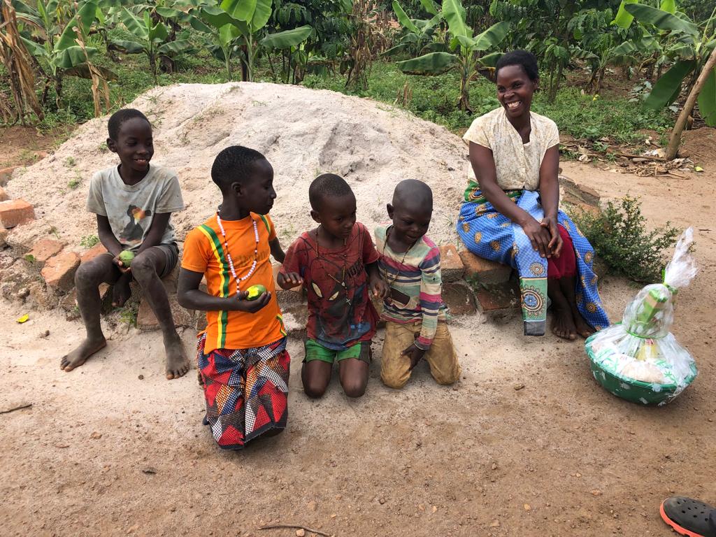A woman and young children smile as they look at their gift basin