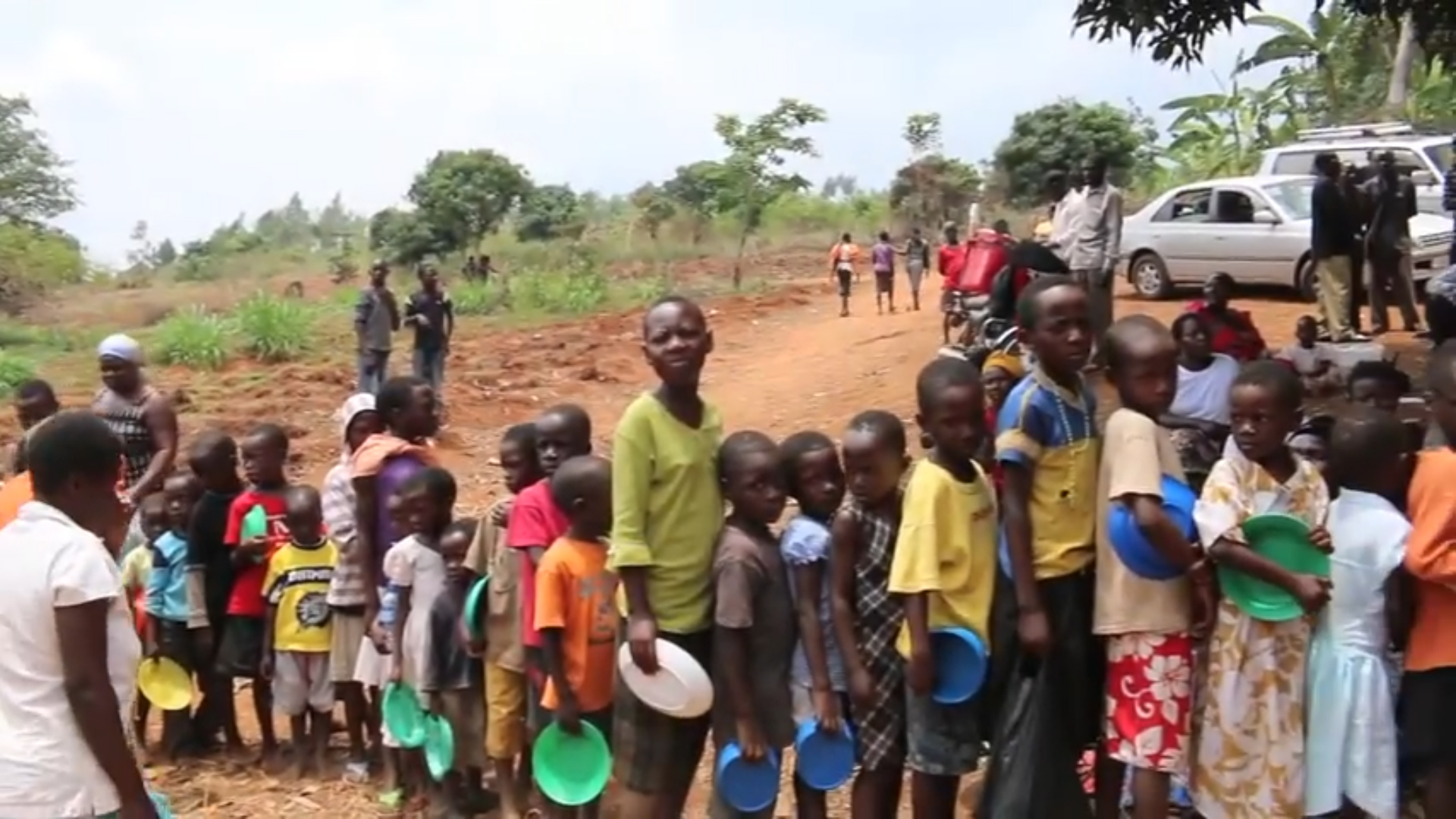kids lined up to get a meal in Uganda