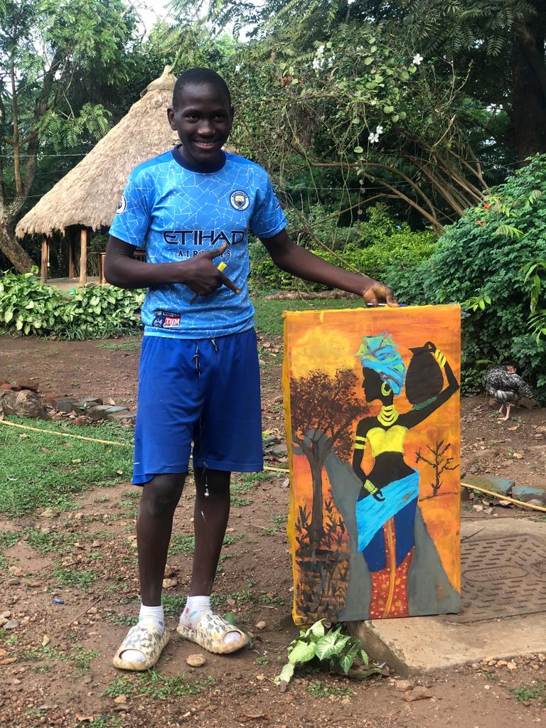 young boy with painting in Uganda