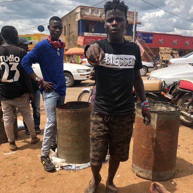 teen boys standing next to barrels