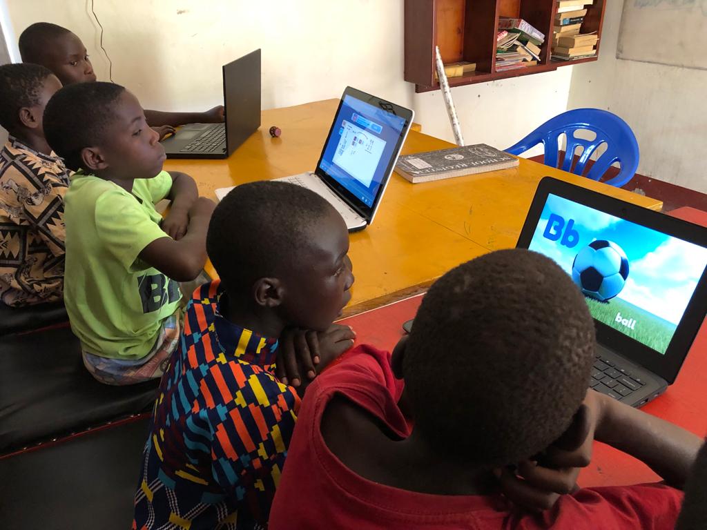 young boys using laptops to learn English