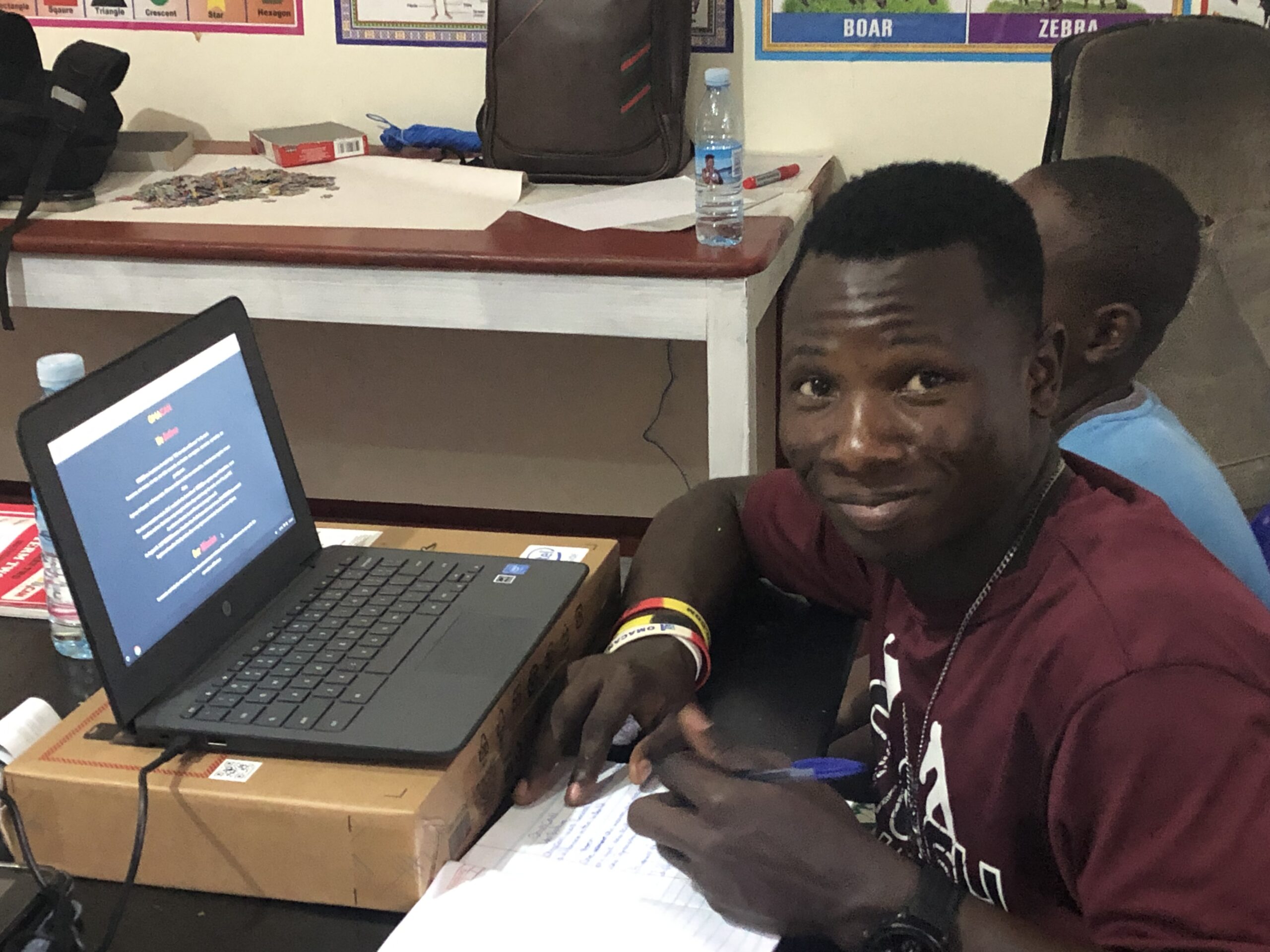 young man sitting at a desk with a laptop