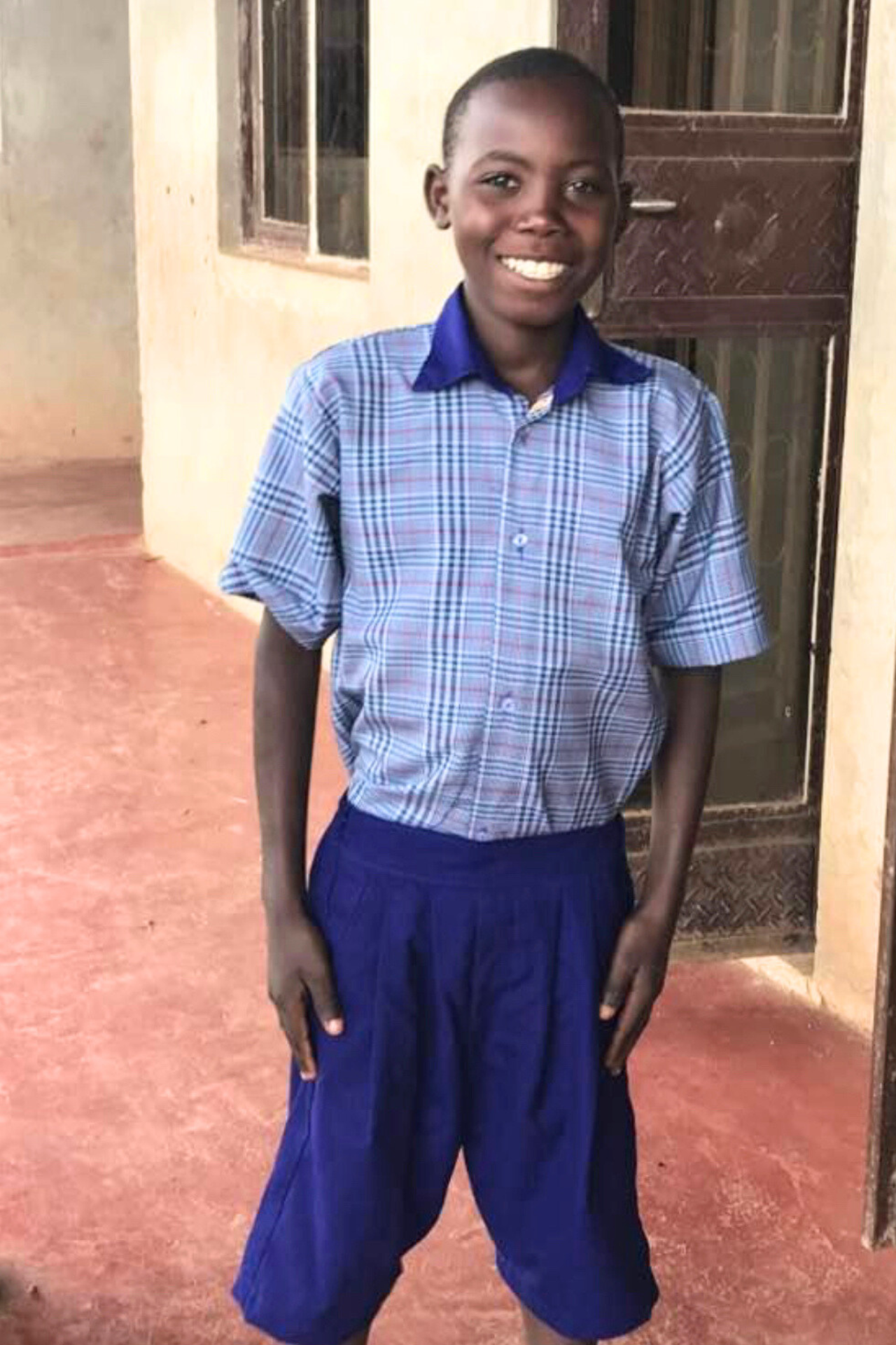 Kakooza in school uniform in Uganda